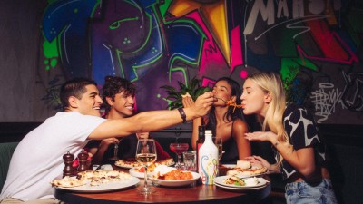 A group enjoying the lively Brunch Alla Italiana event at IL Motto Pizzeria.