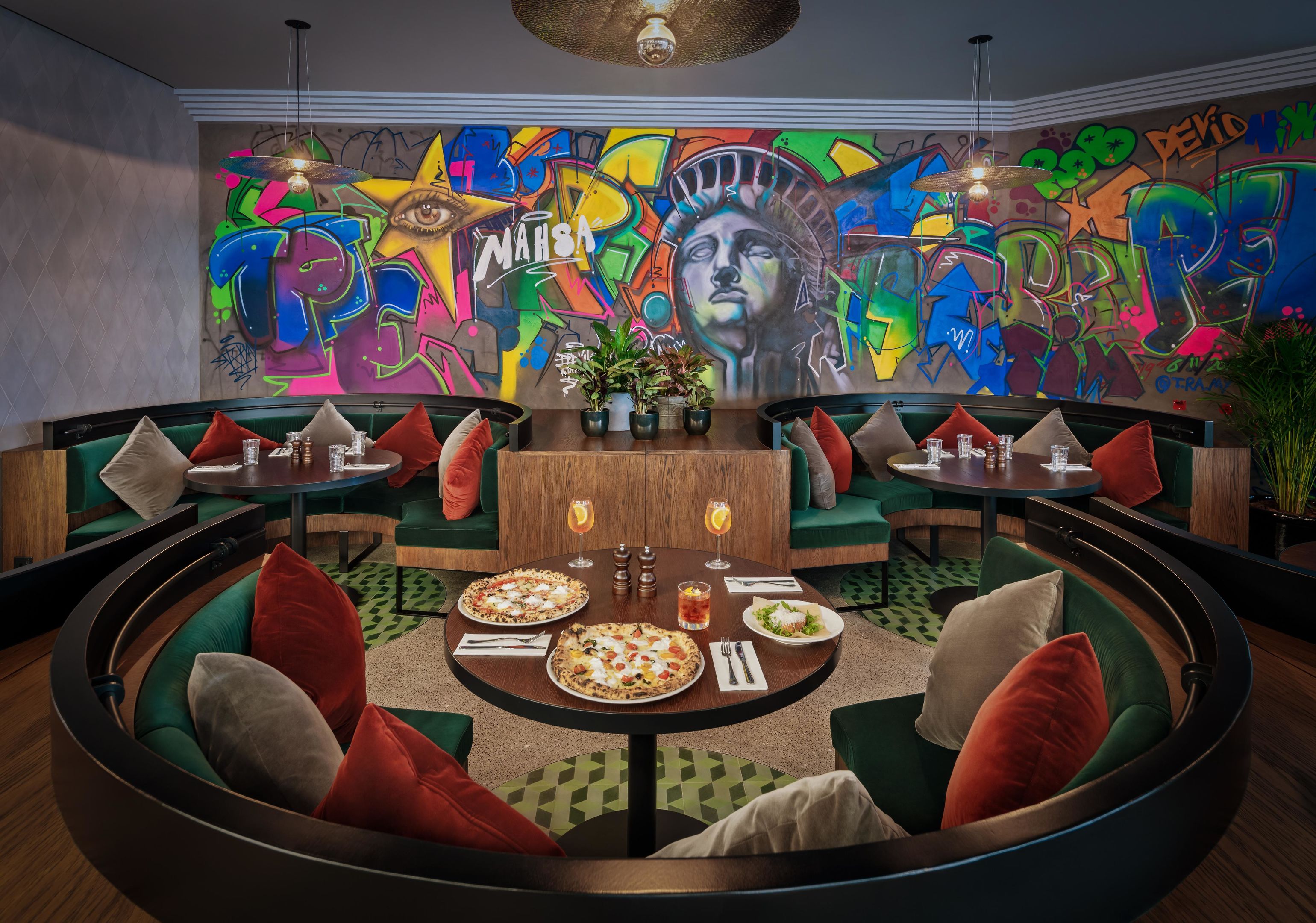The vibrant interior of IL Motto Pizzeria featuring unique graffiti wall art.