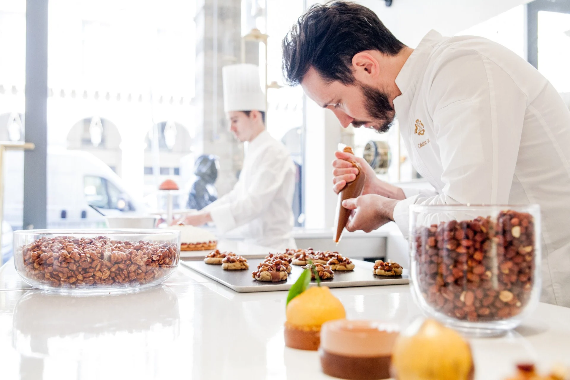Pastry chefs at work in Cedric Grolet's kitchen, creating his renowned desserts.