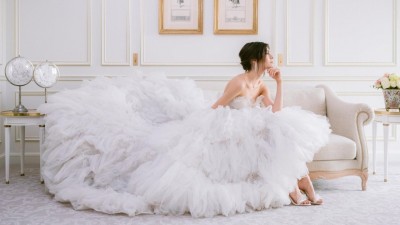 A bride in a wedding gown enjoys a contemplative moment at Le Meurice.