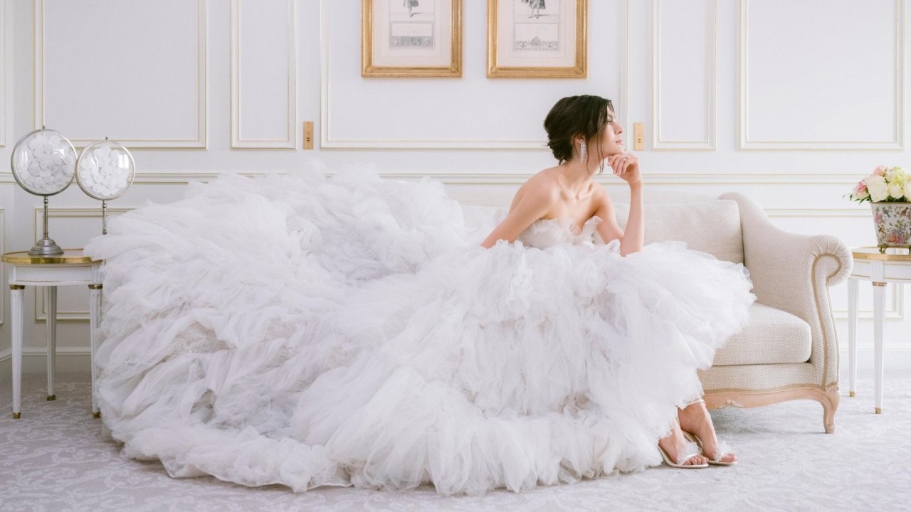 A bride in a wedding gown enjoys a contemplative moment at Le Meurice.