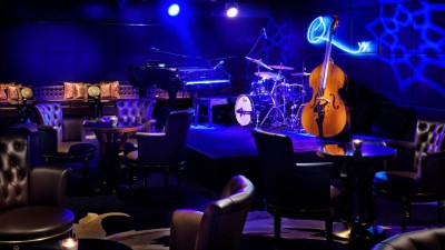 The vibrant entertainment lounge at Q's Bar, featuring a dedicated karaoke area for live performances.