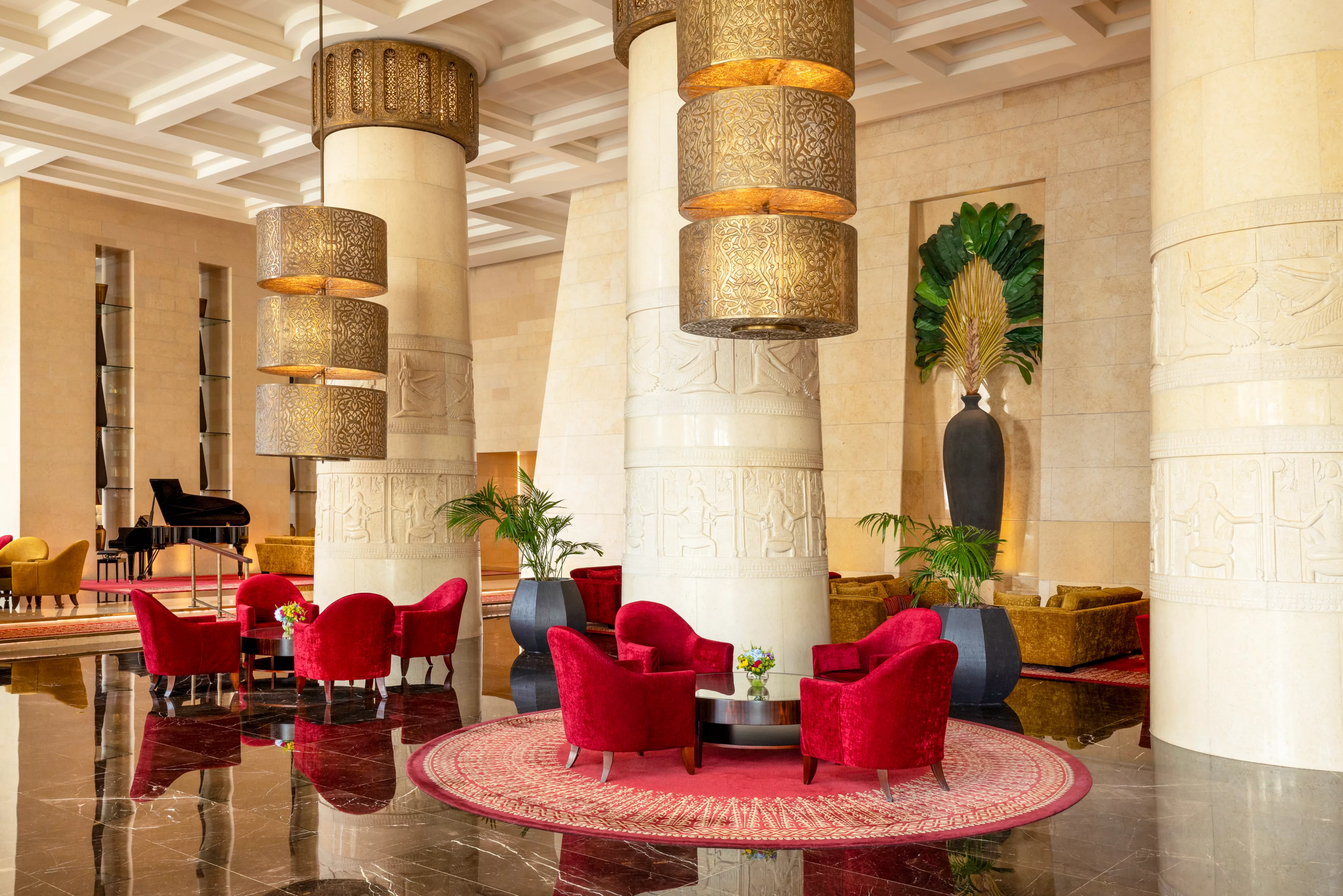 The elegant Raffles Salon lobby lounge, adorned with Egyptian-inspired hieroglyphic columns.