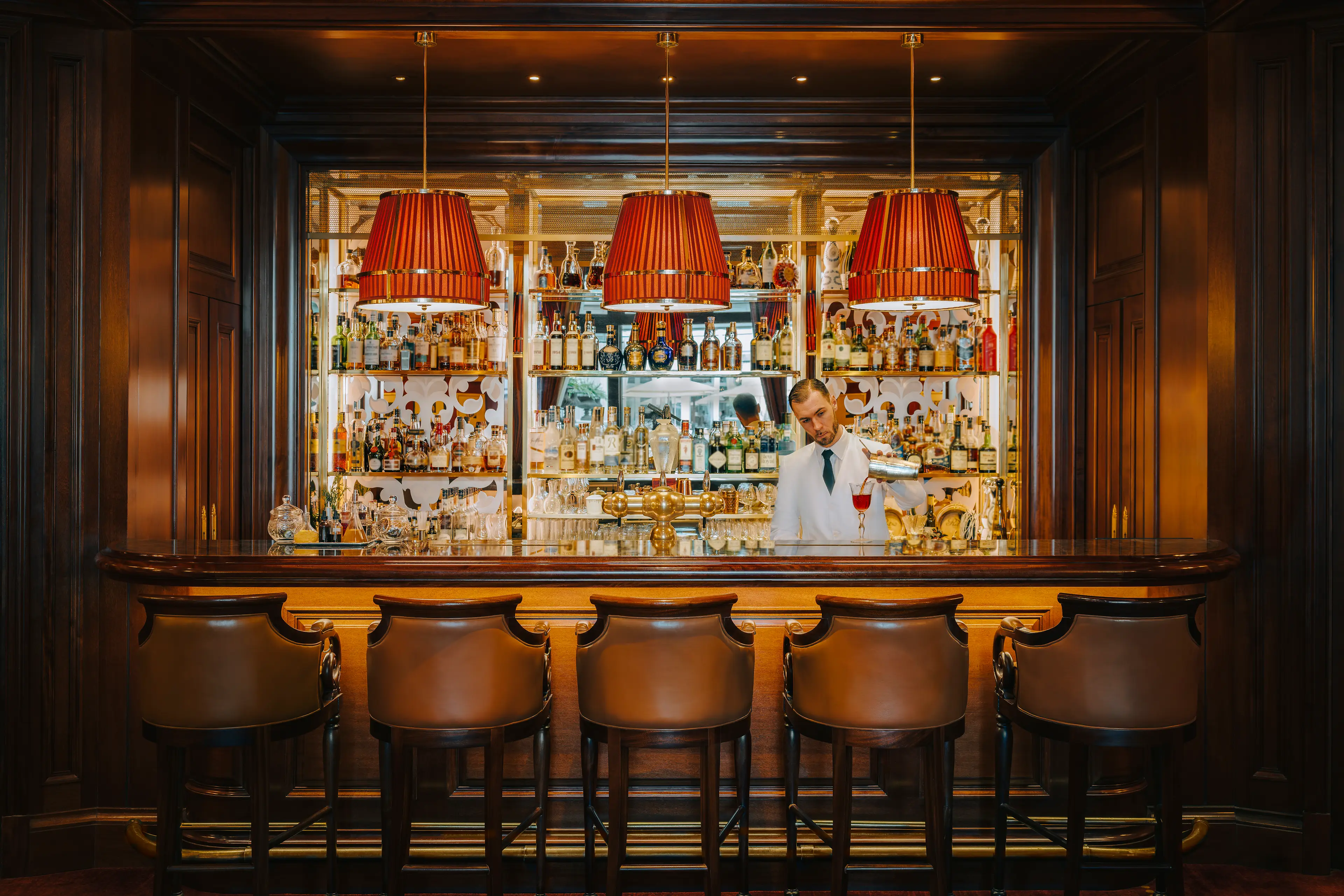 The elegant central bar counter at Bar Vendôme, under the stunning glass roof.