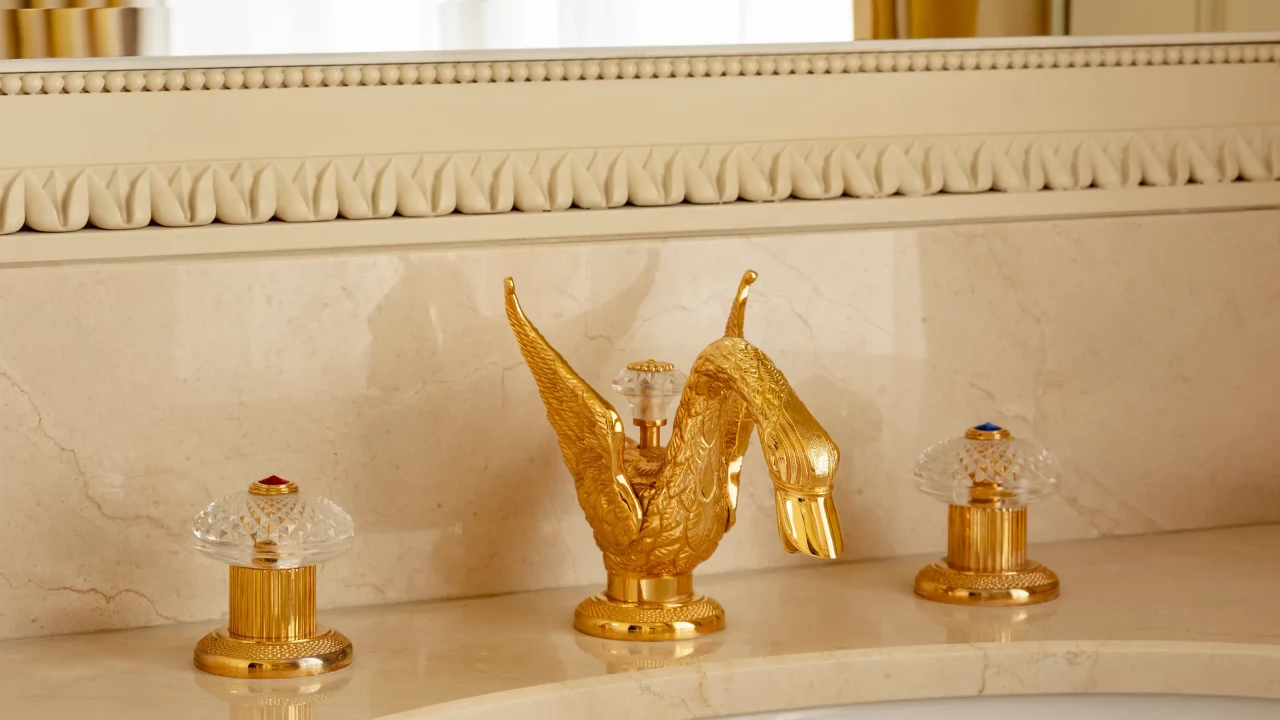 The iconic 24-carat gold-plated swan faucets, a symbol of Ritz Paris bathroom luxury.