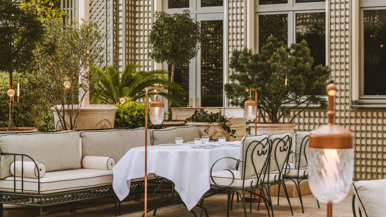 An inviting alfresco table setting on Espadon's terrace, perfect for a summer evening.