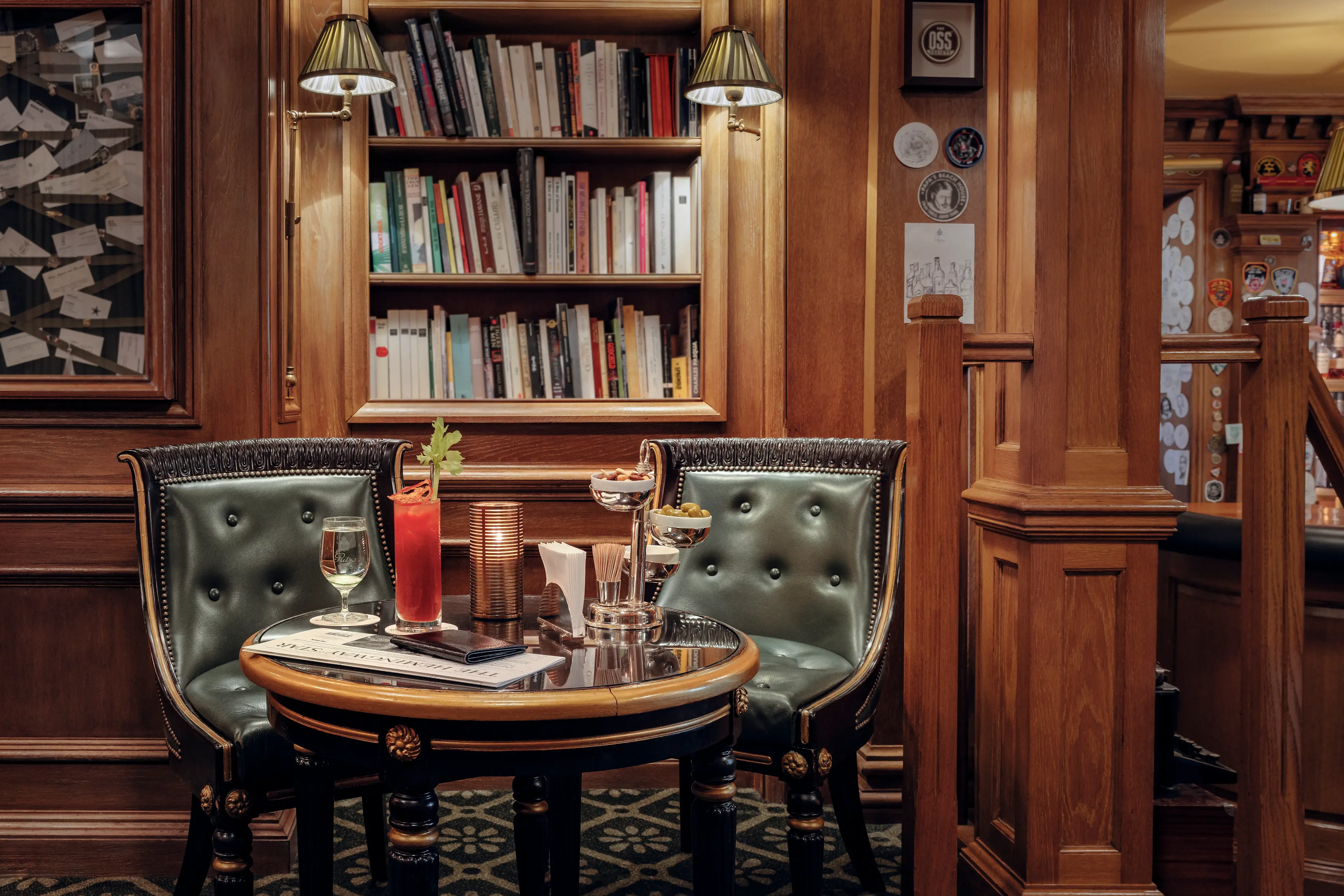 The intimate, book-lined library corner within Bar Hemingway, steeped in literary history.