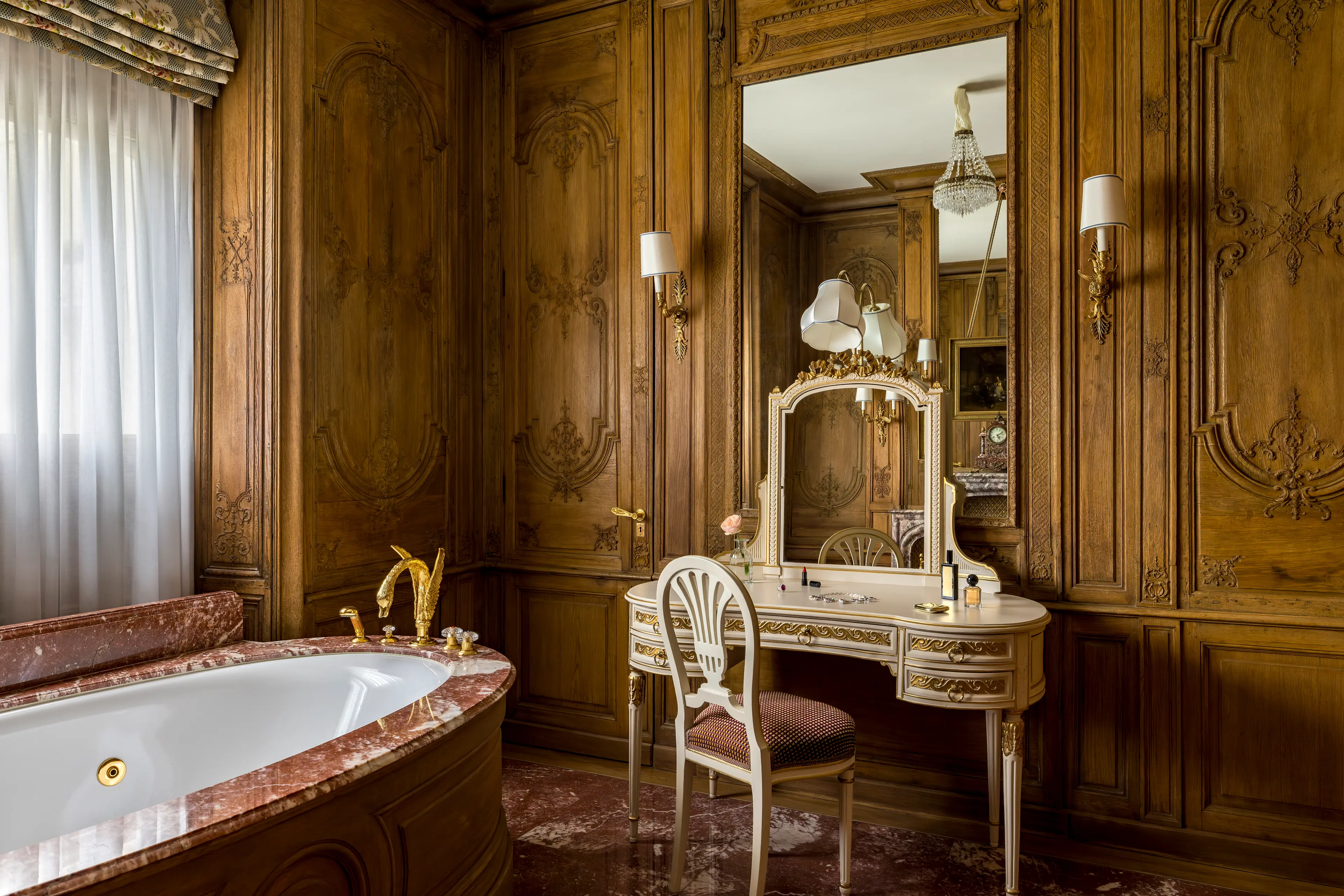 The opulent, oak-paneled marble bathroom in the Suite Impériale.