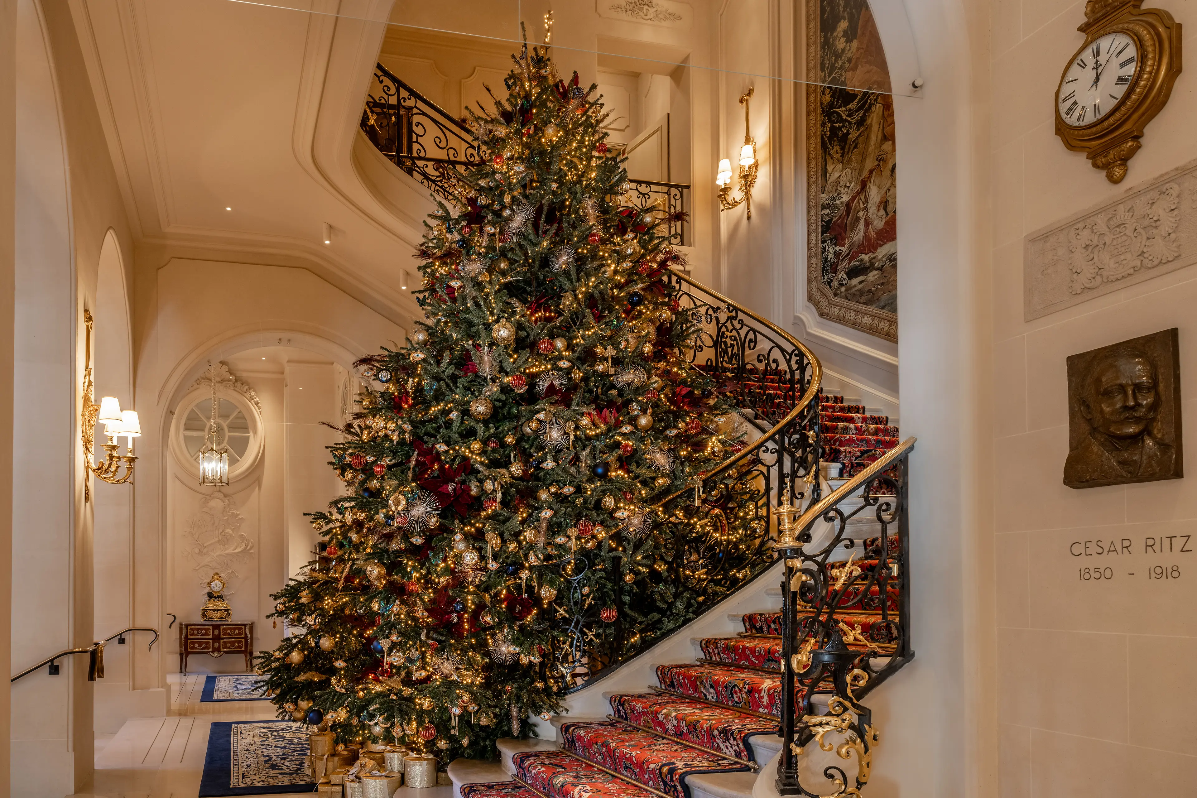 The grand lobby of the Ritz Paris adorned with a majestic Christmas tree, showcasing the hotel's festive holiday decorations.