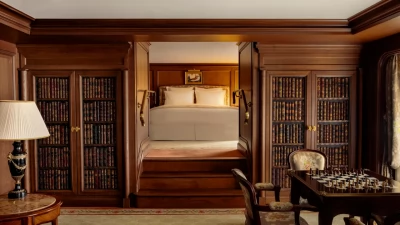 The intimate, wood-paneled living room of the Suite Marcel Proust, inspiring literary reflection.