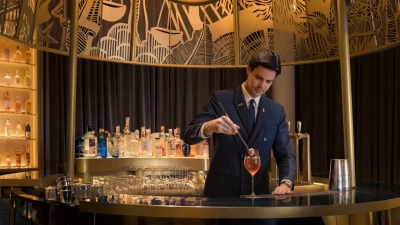 Ritz Bar's Chef Barman Romain de Courcy meticulously preparing one of his signature biodynamic cocktails.