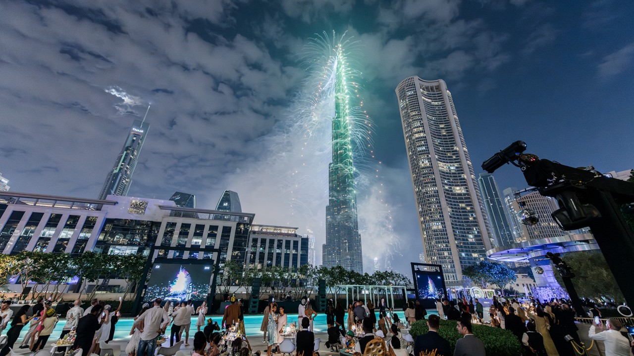 Guests celebrating New Year's Eve at the outdoor gala dinner on Deck Too, Address Sky View, with front-row views of the Burj Khalifa fireworks.