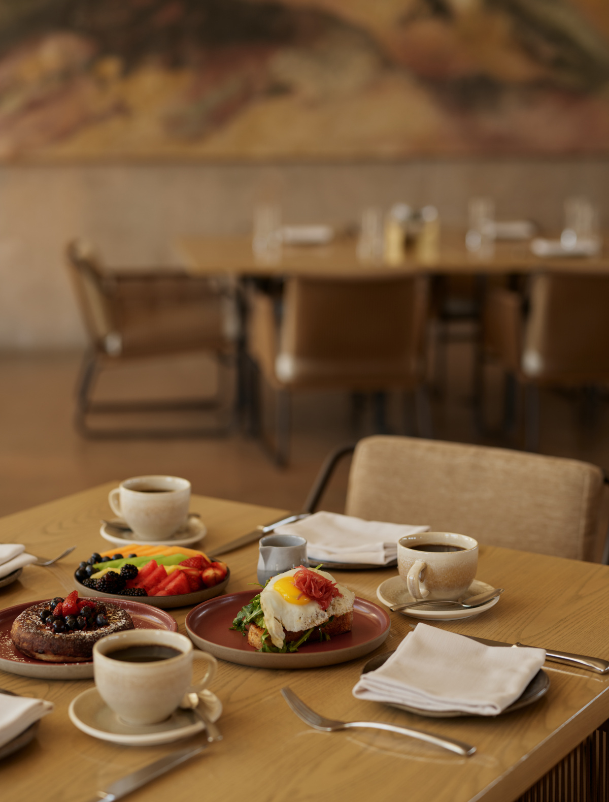 An elegant breakfast table setting inside the Amangiri Resort restaurant with panoramic desert views.