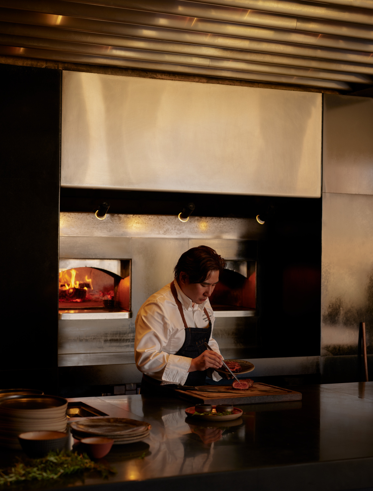 A chef presents meat freshly roasted in the wood-burning oven at the main restaurant of Amangiri Resort.