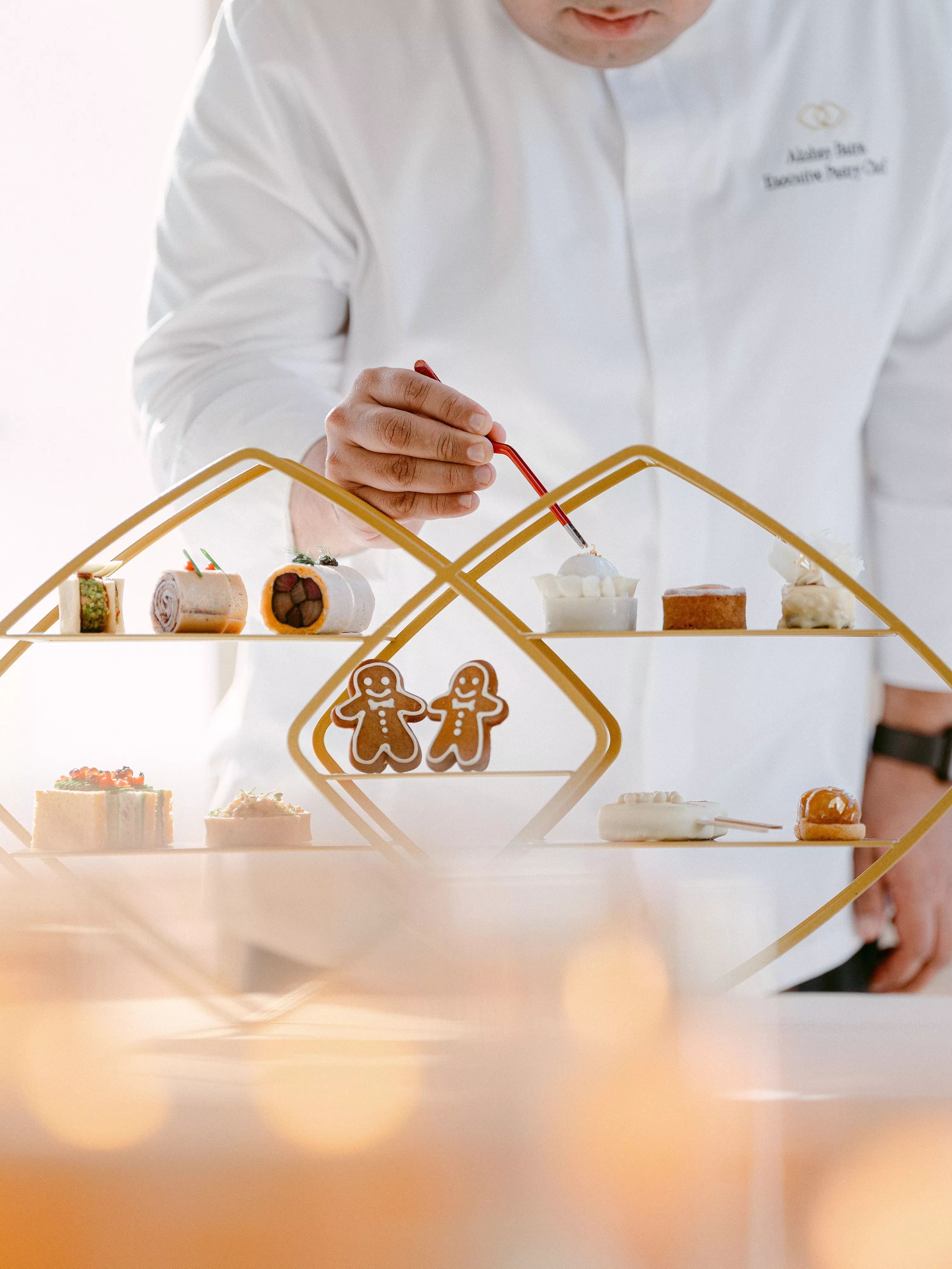 A Sofitel chef carefully prepares festive, concept-themed cookies for the Golden Afternoon Tea at Olivier's Lounge.